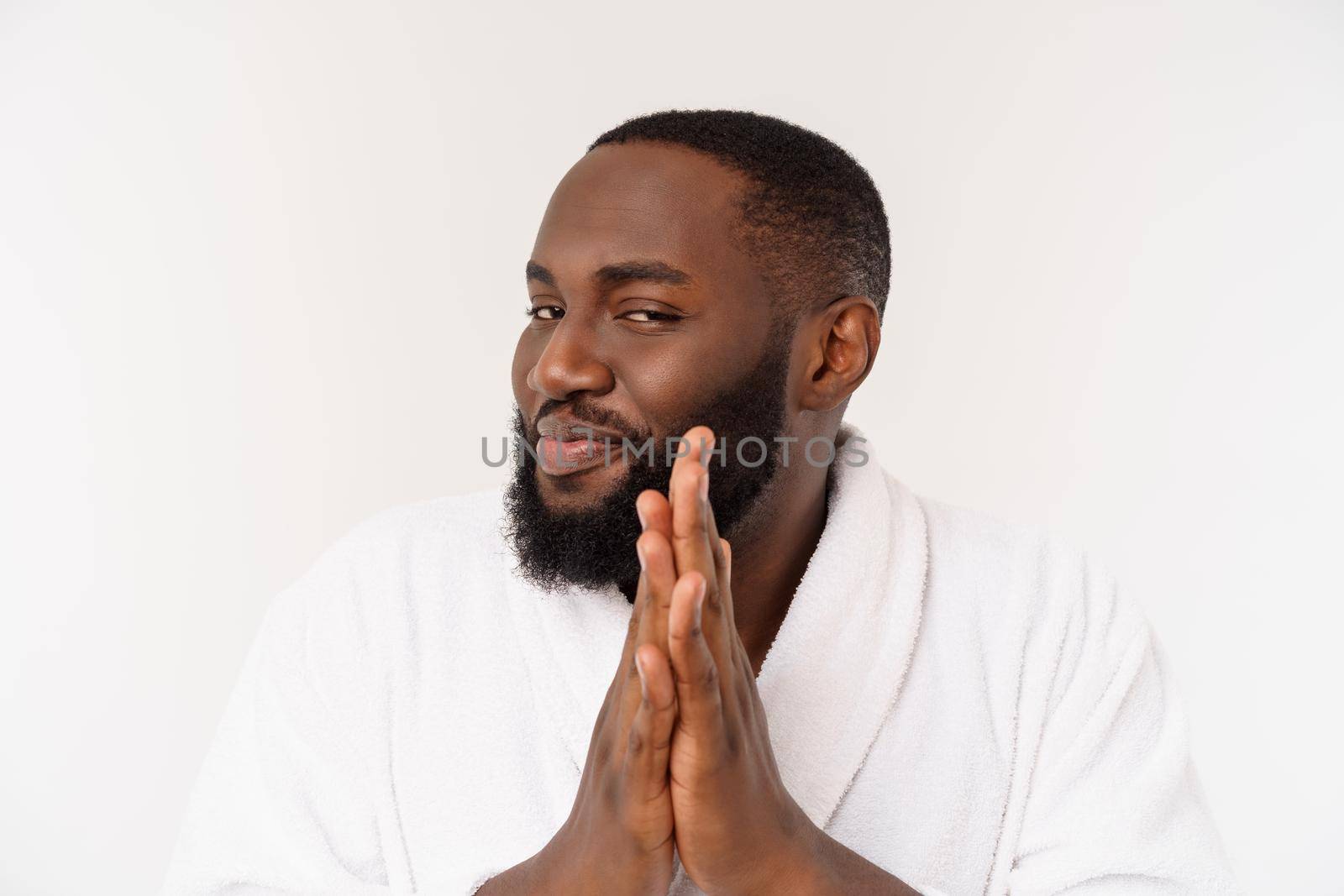 Black guy wearing a bathrobe pointing finger with surprise and happy emotion. Isolated over whtie background