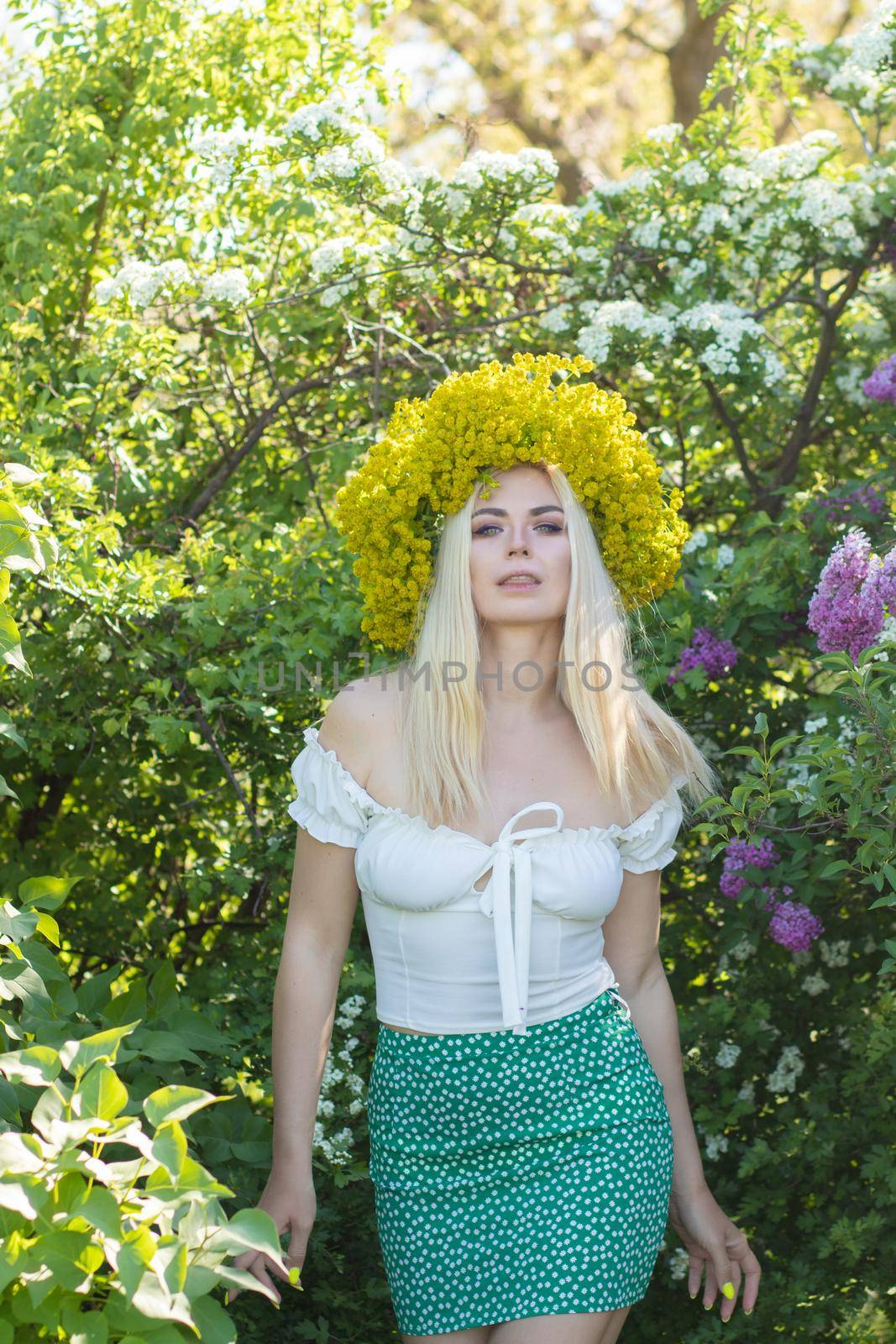 Blonde woman with yellow flower wreath in springtime by Bonda