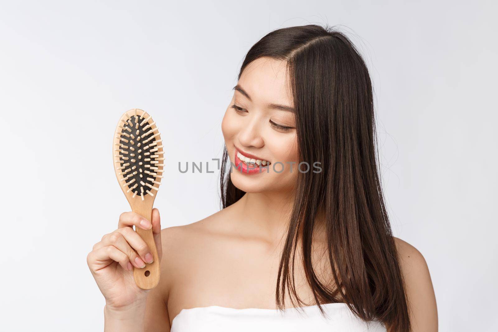 portrait of a beautiful young woman comb wonderful hair isolated on white background, asian beauty.