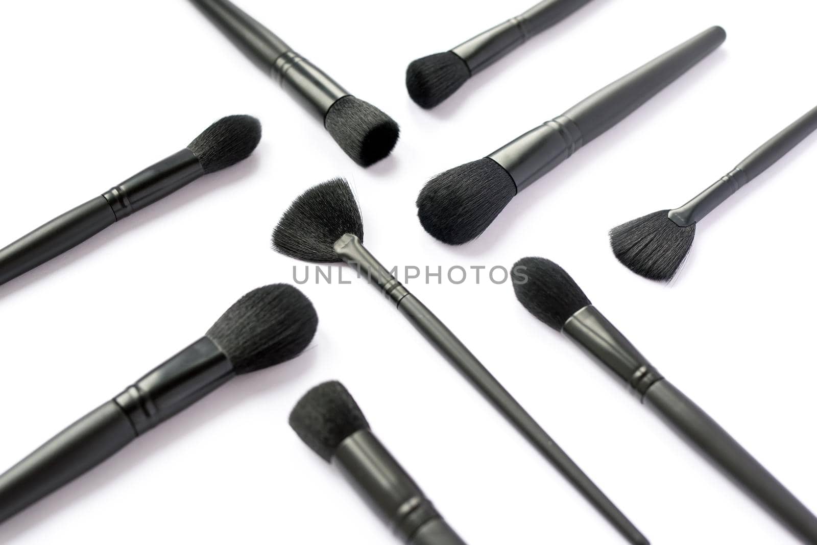 Makeup brushes collection from top side angle isolated on white background.