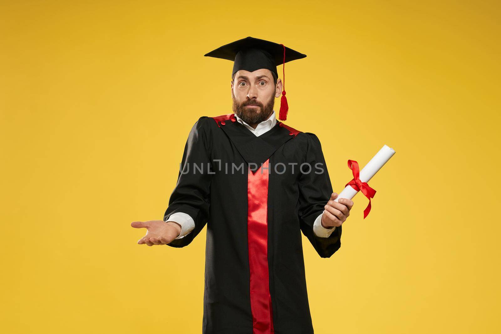 Male with beard standing, holding diploma, surprised, mixed up. by SerhiiBobyk