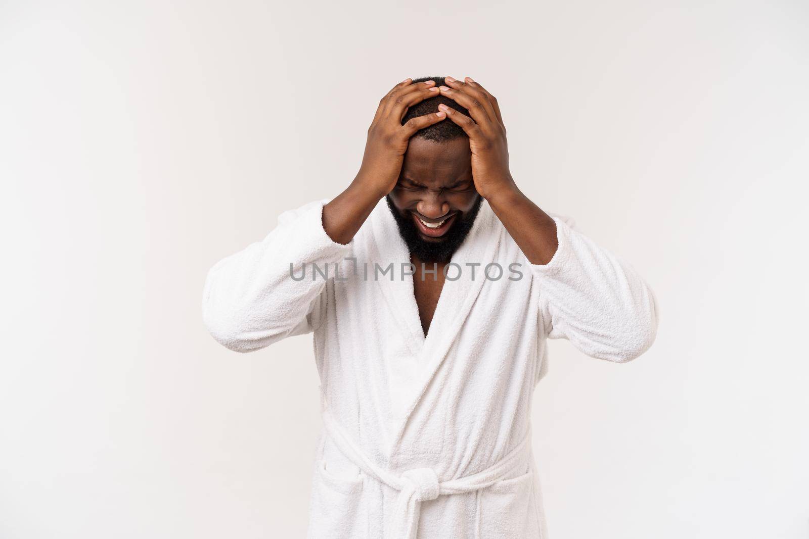 Young african american man wearing bathrobe over isolated white background thinking looking tired and bored with depression problems