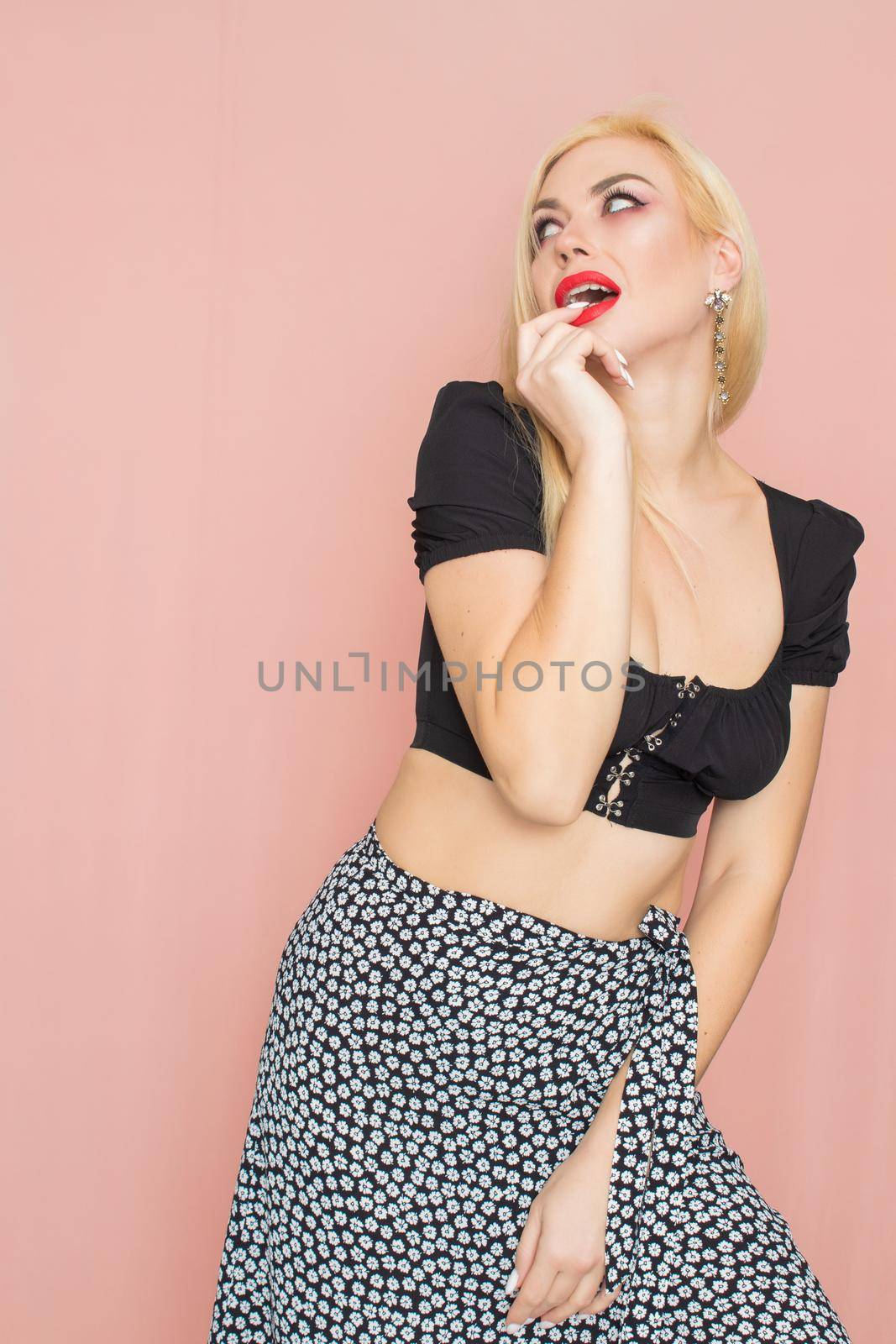 Summer fashion portrait blonde woman. Sexy look in black top and skirt. Red lips