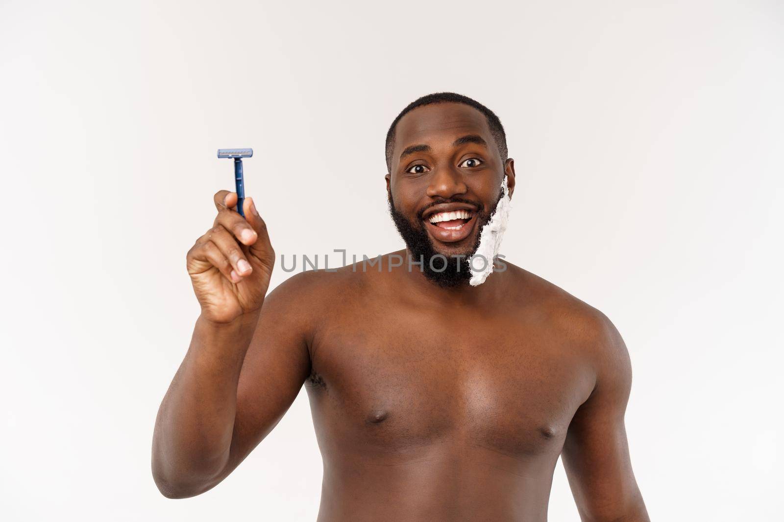 Young Afro American Man Shaving in Bathroom. Personal Morning Routine. Hygiene at Morning Concept