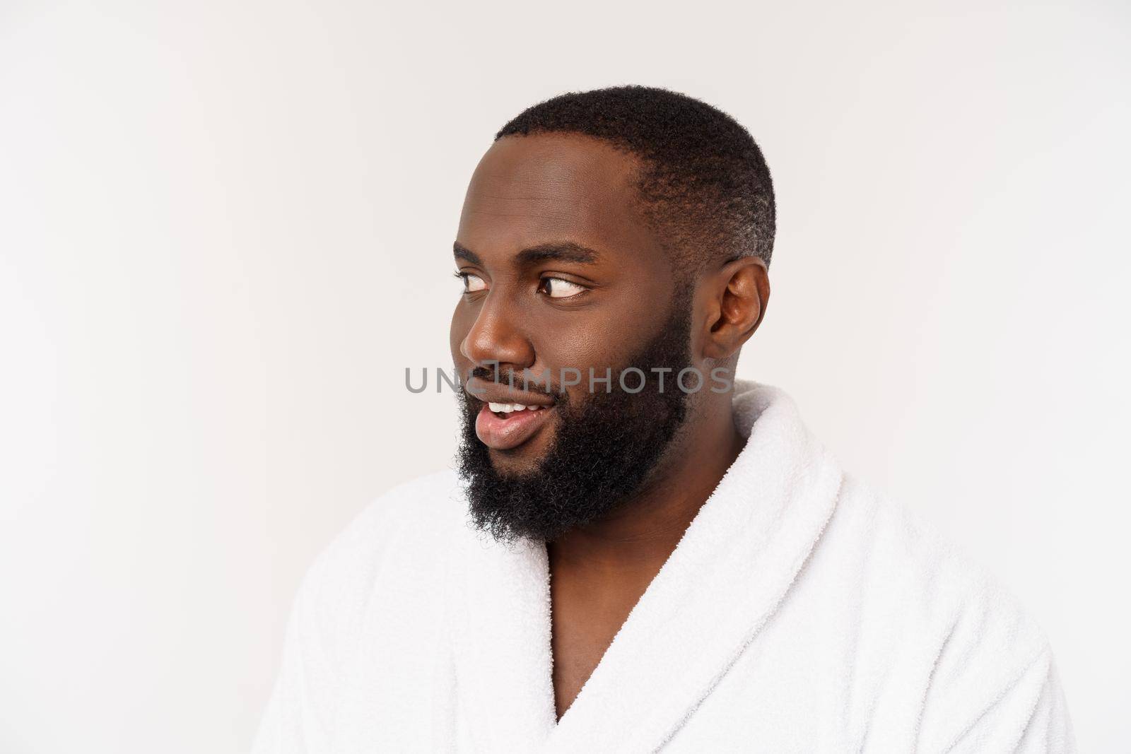 African American man wearing a bathrobe with surprise and happy emotion. Isolated over whtie background.