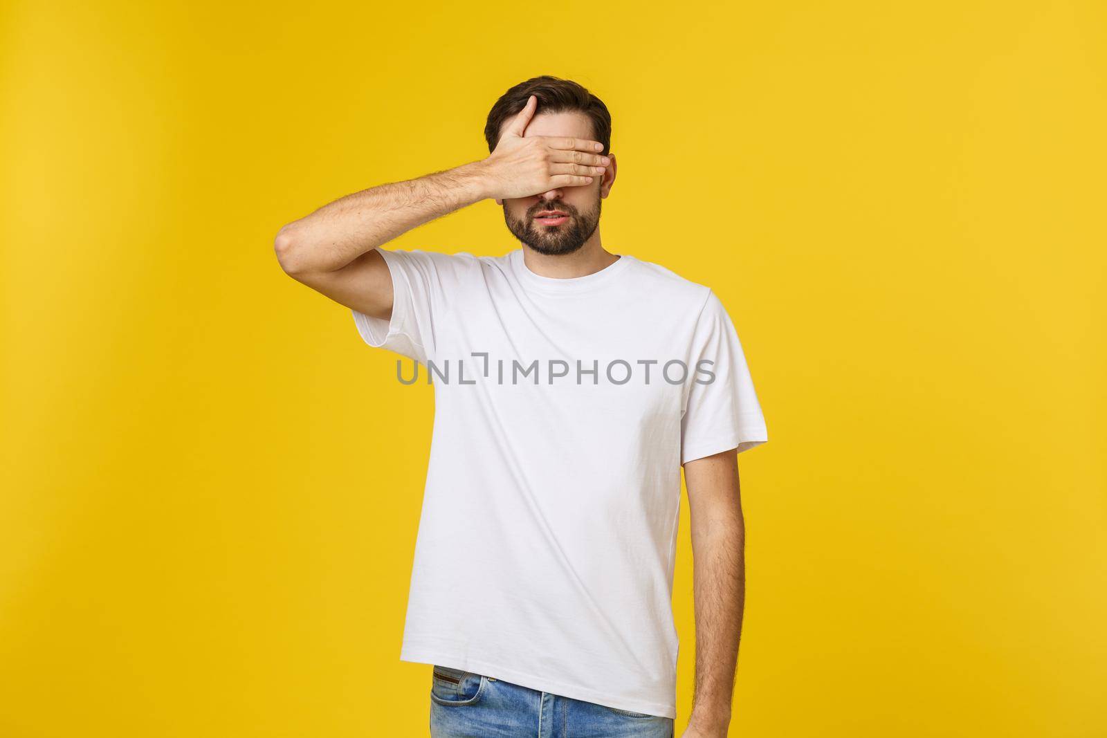 Young caucasian handsome man isolated on beige background covering eyes by hands. Do not want to see something. by Benzoix