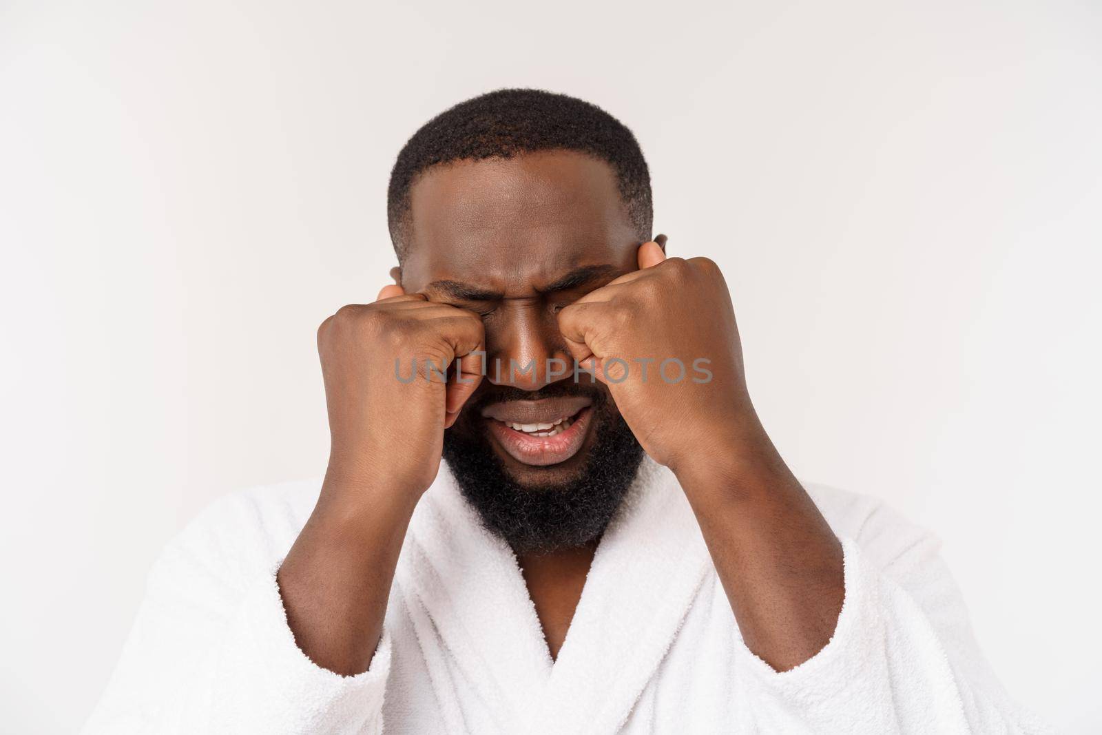 African American man wearing a bathrobe with surprise and happy emotion. Isolated over whtie background.