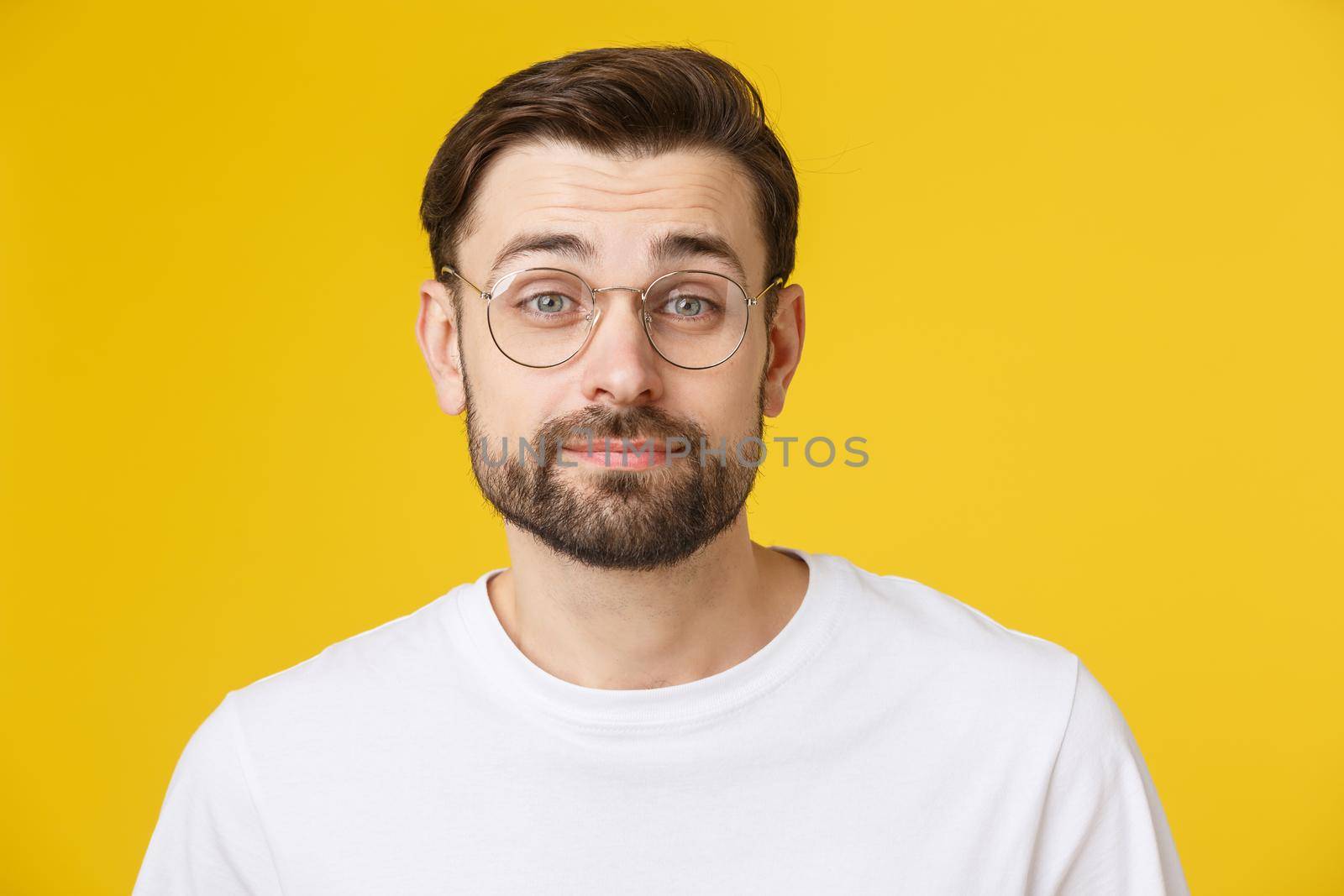 Young casual man portrait isolated on yellow background.