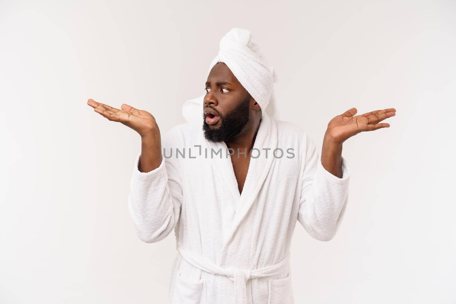 Black guy wearing a bathrobe pointing finger with surprise and happy emotion. Isolated over whtie background. by Benzoix
