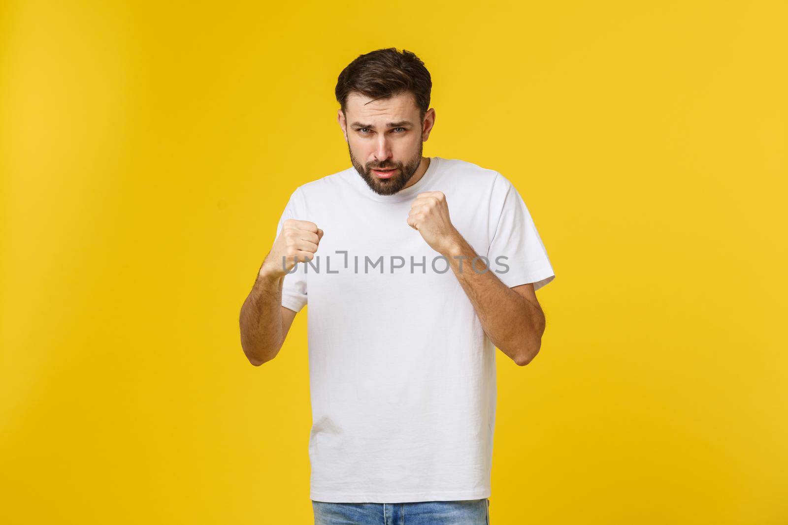 Young blond curly hair caucasian man isolated throwing a punch, anger, fighting due to an argument, boxing by Benzoix