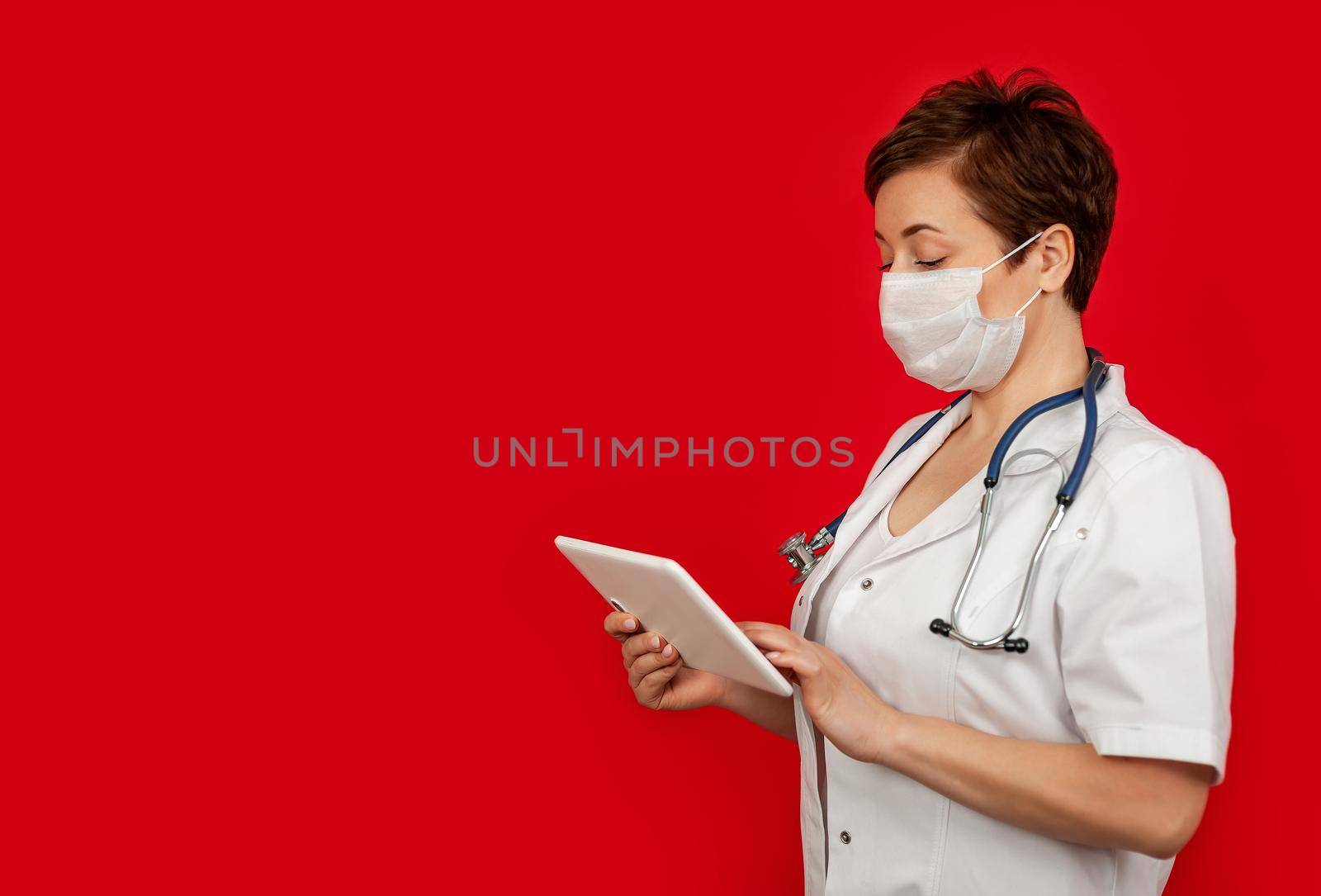 Portrait of a female doctor using her digital tablet. Female doctor using tablet and checking with analysis on a virtual interface. Medicine. Medical science and biotechnology.
