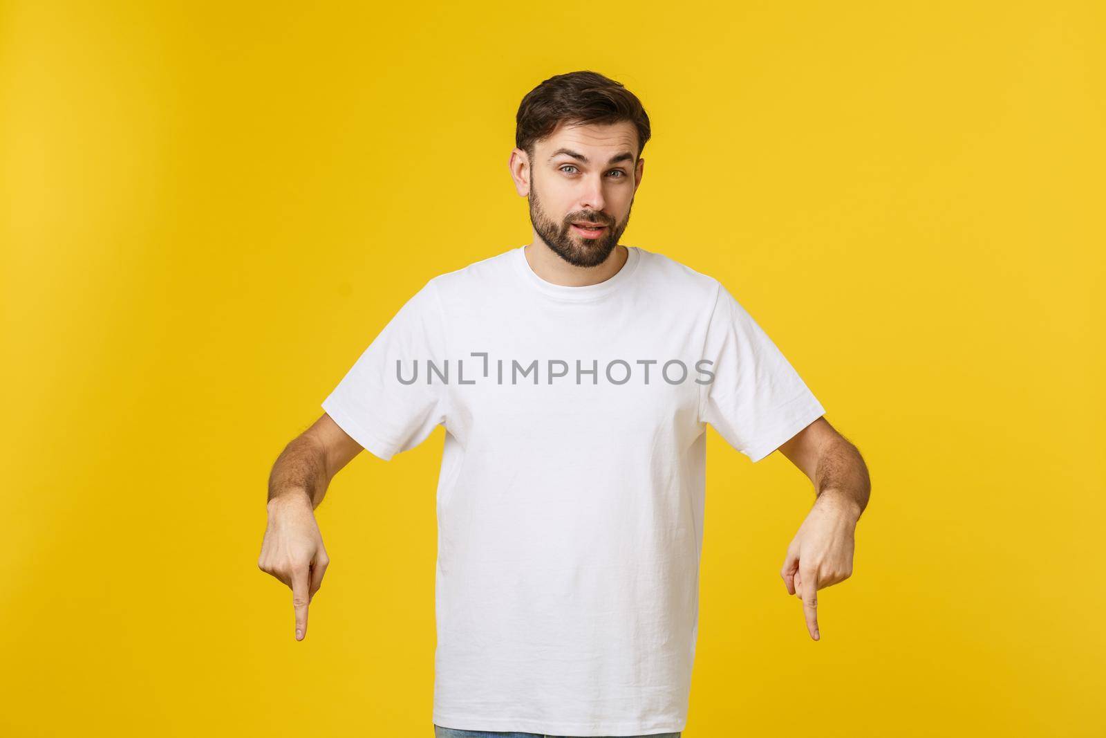 Handsome man over isolated yellow wall frustrated and pointing to the front. by Benzoix