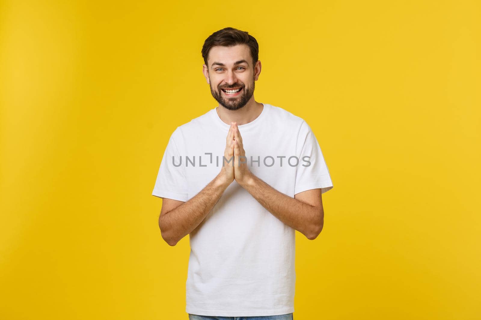 Calm and handsome. Portrait of handsome young man keeping hands clasped and looking thoughtful