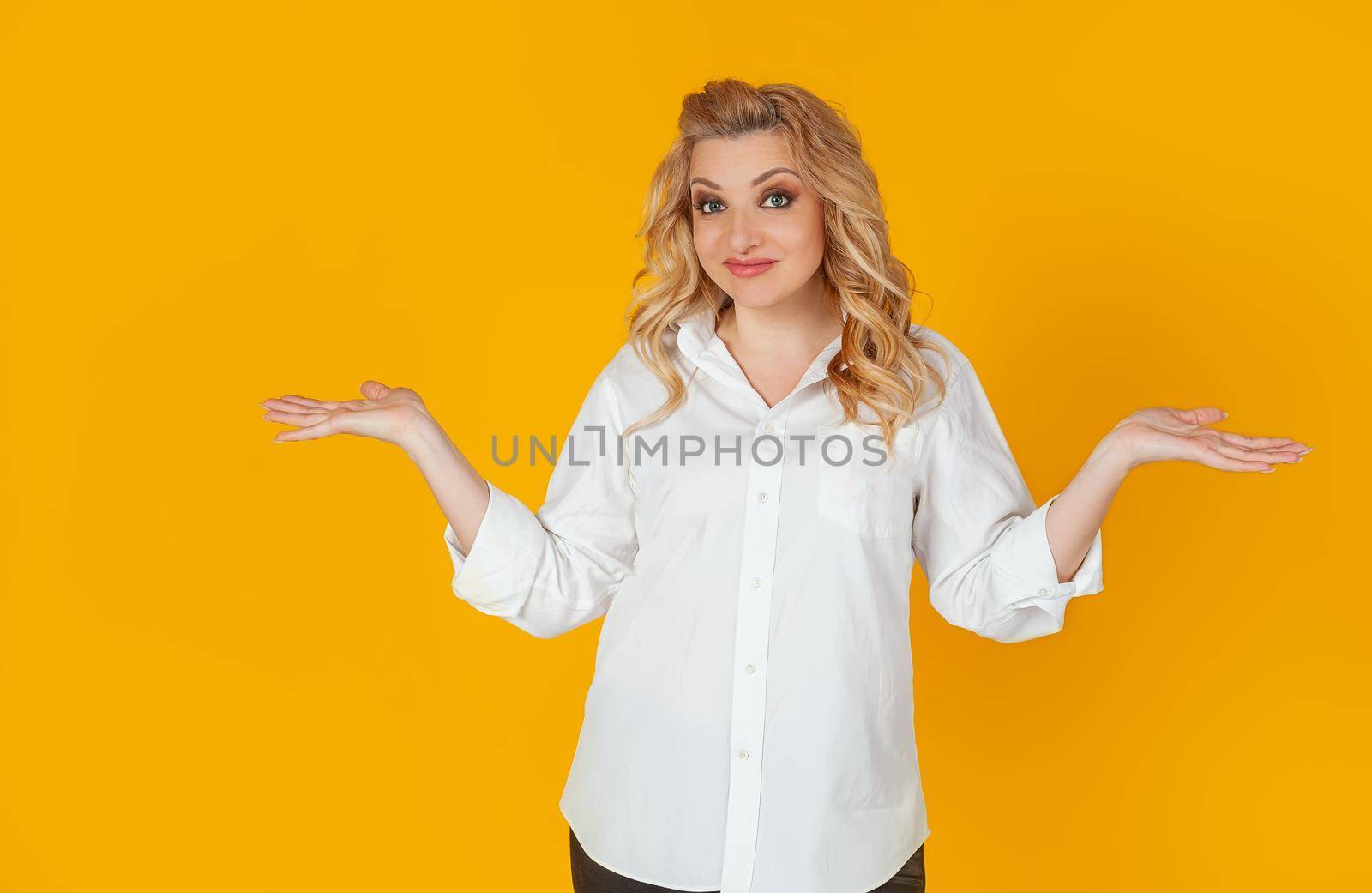 Frustrated gloomy upset confused Caucasian pretty blonde shrugs, arms outstretched, complete disbelief in doubt to say the answer have no idea. I dont know.