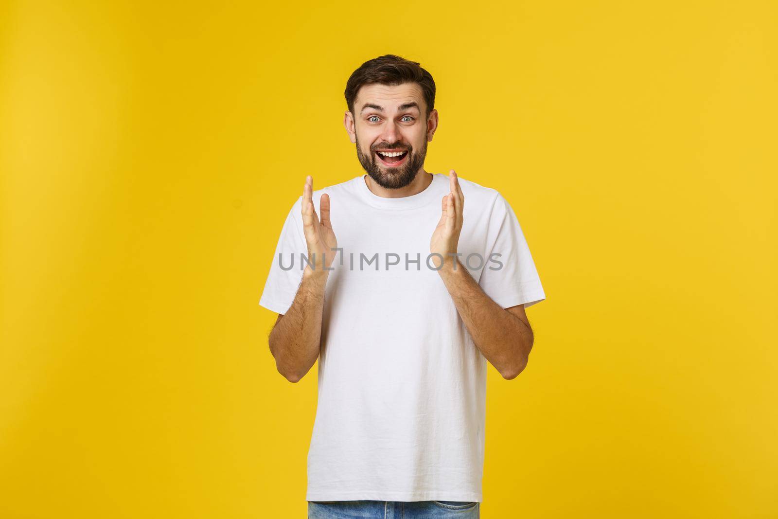 Young handsome elegant man over isolated background Clapping and applauding happy and joyful, smiling proud hands together. by Benzoix