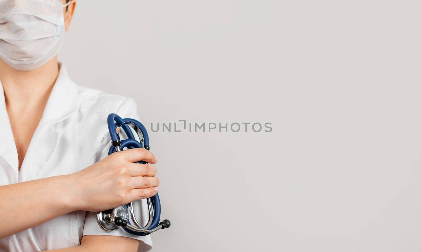 Healthcare and medical concept. A doctor with a stethoscope in his hand. Female doctor pediatrician holding a stethoscope in hand