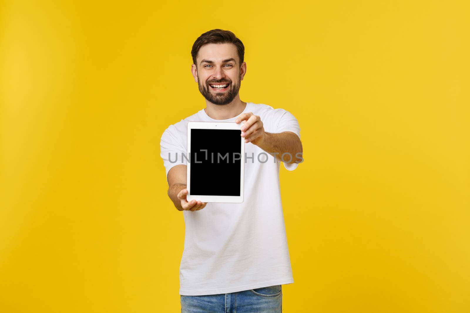 Creative young programmer presents with a smile on his face display a tablet. by Benzoix