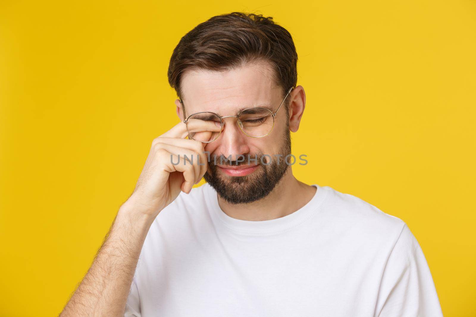 Close up portrait of handsome desperate young man suffering from depression looking miserable, melancholy and sad. by Benzoix