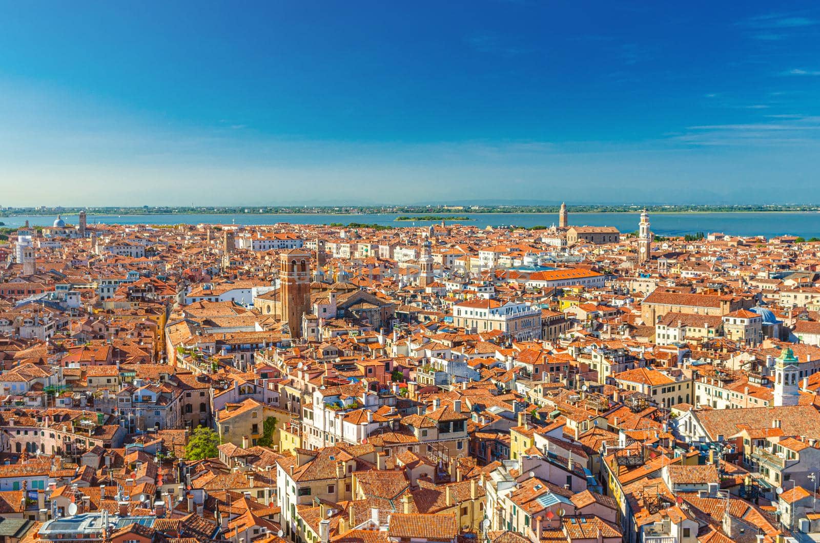 Aerial panoramic view of Venice city old historical centre, buildings with red tiled roofs, San Giuliano Mestre and blue sky background, Veneto Region, Northern Italy. Amazing Venice cityscape.
