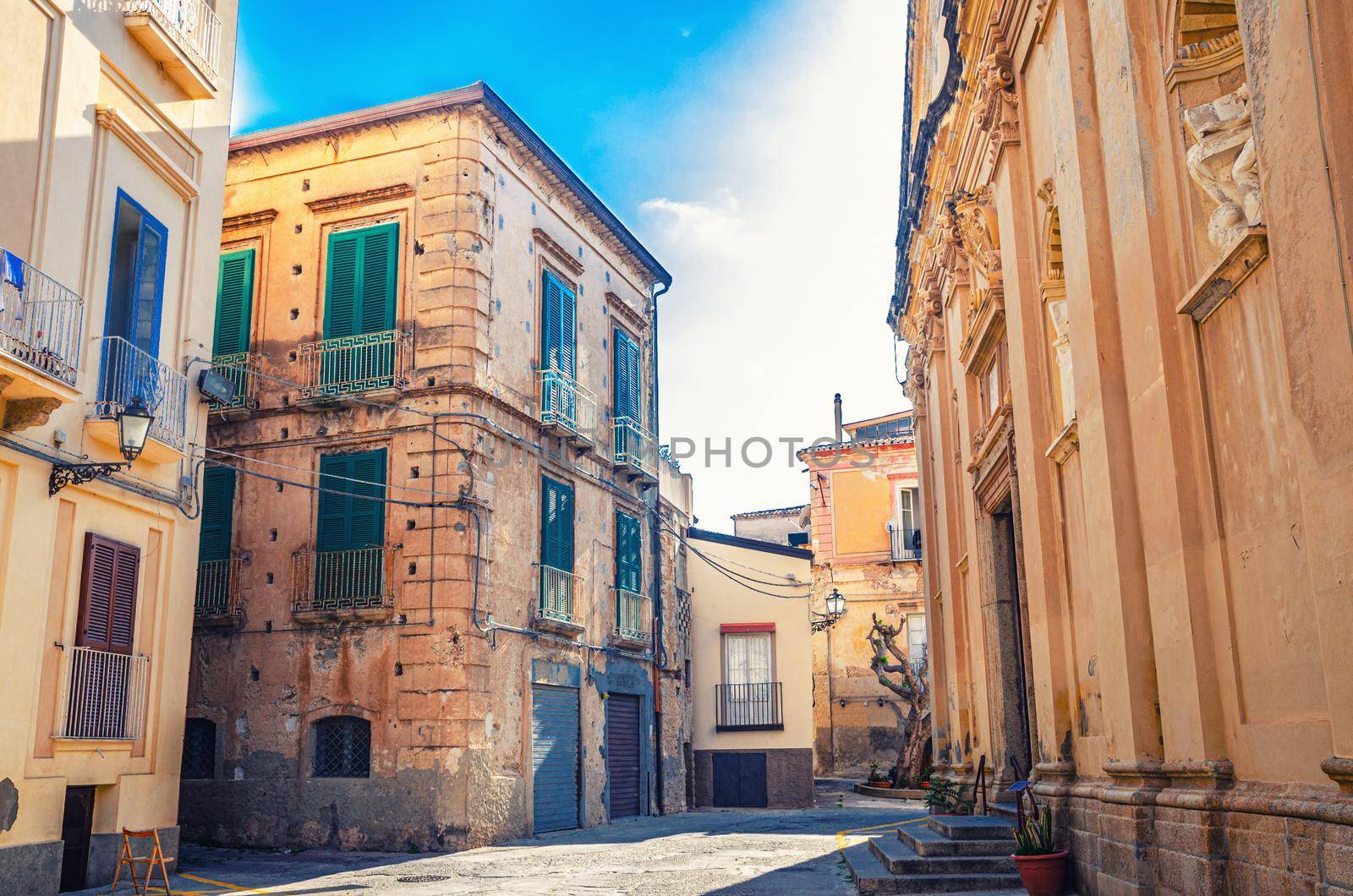 Typical italian narrow street of Tropea town historical centre with old buildings and Church of Jesus of the Convent of the Fathers Redemptorists, Vibo Valentia, Calabria, Southern Italy