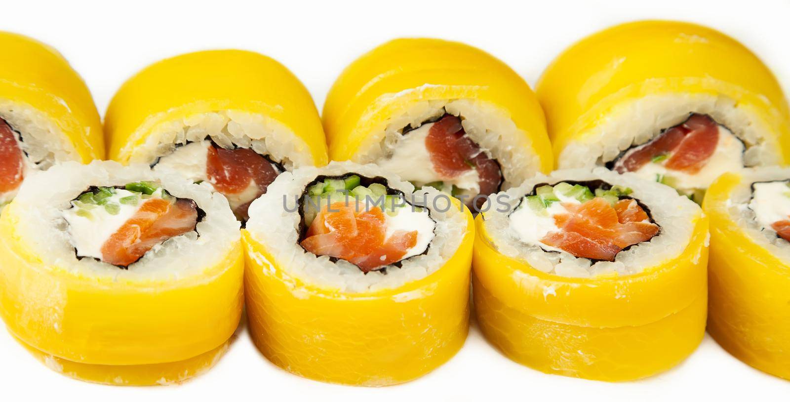 Sushi roll with takuan and smoked salmon on a white plate, classic Japanese sushi. Traditional Japanese food with maki Delicious pieces of sushi For the restaurant menu. Copy Space