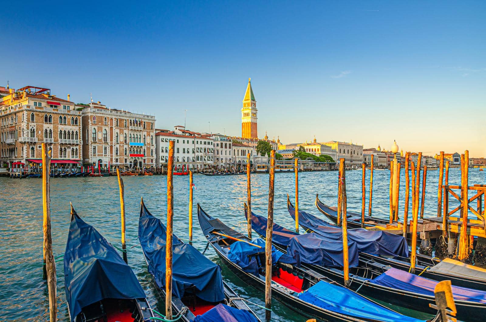 Gondolas moored in water of Grand Canal waterway in Venice by Aliaksandr_Antanovich