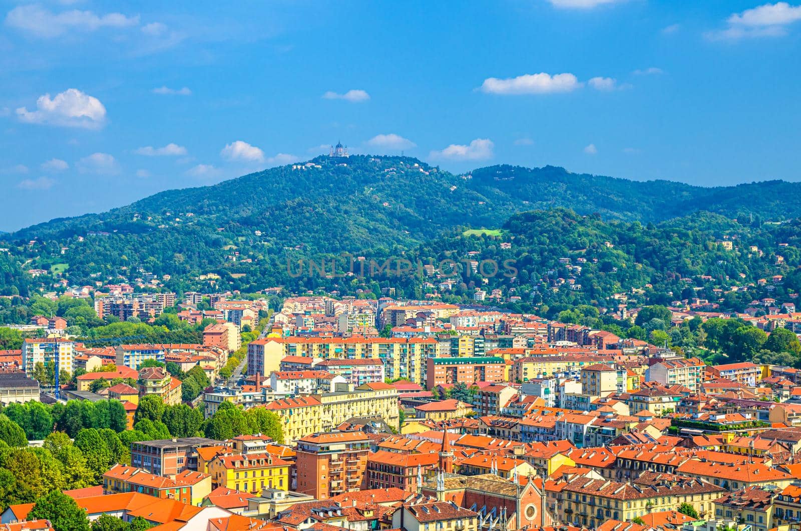 Aerial view Turin Borgo Po district quarter and Basilica di Superga Catholic church on hill from Santa Maria del Monte dei Cappuccini platform, blue sky white clouds background, Piedmont, Italy