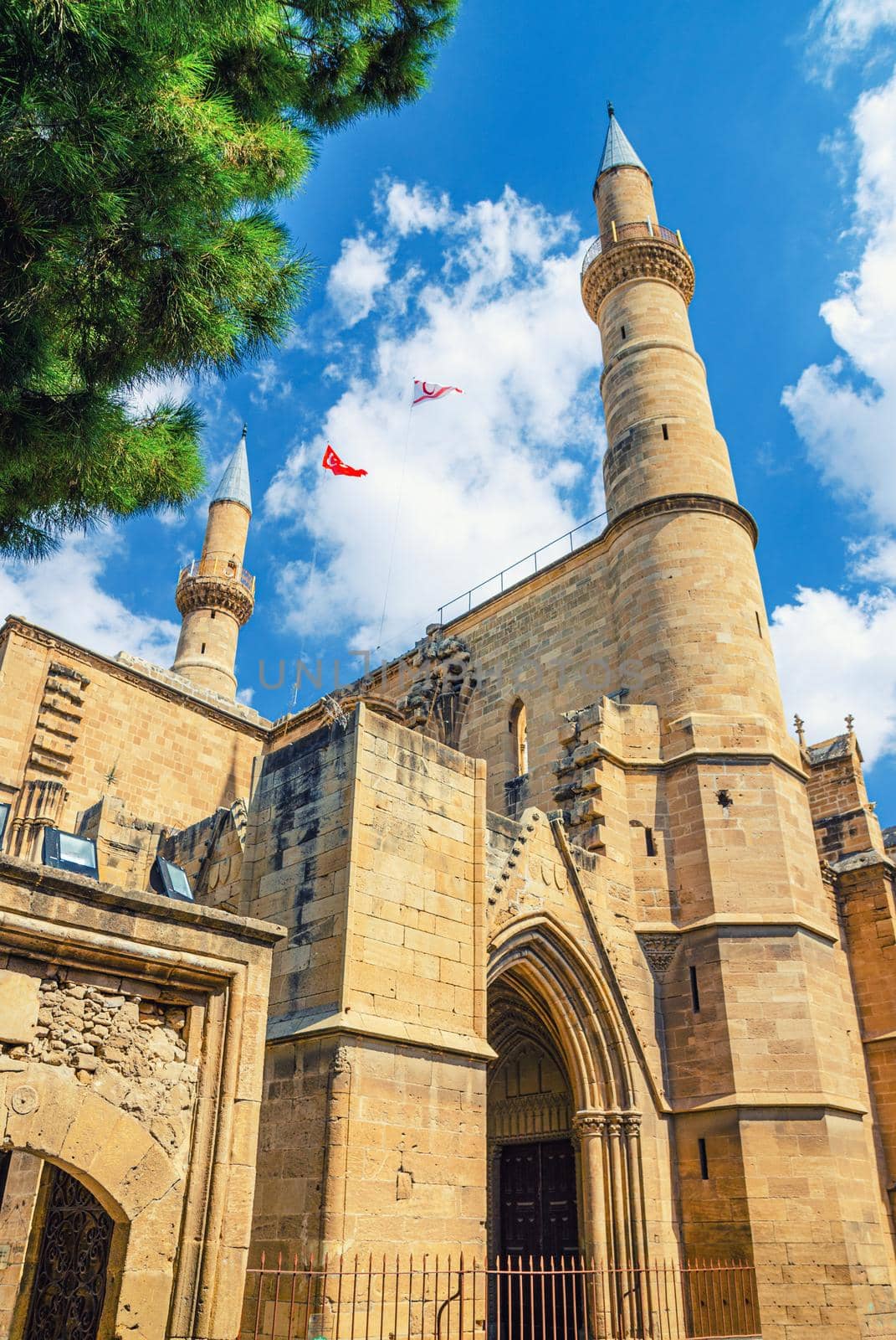 Selimiye Mosque or Cathedral of Saint Sophia or Ayasofya Mosque building with minarets in North Nicosia historical city centre, blue sky white clouds background, Cyprus