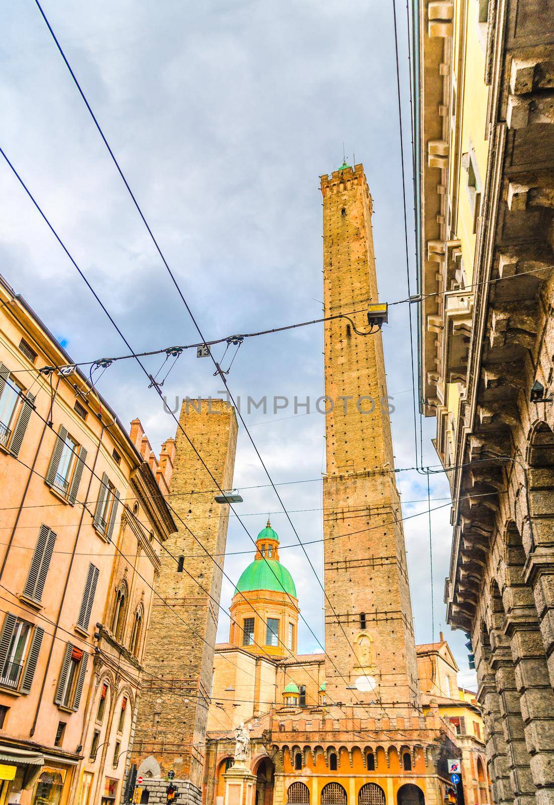 Two medieval towers of Bologna Le Due Torri: Asinelli and Garisenda and Chiesa di San Bartolomeo Gaetano church on Piazza di Porta Ravegnana square in old historical city centre, Emilia-Romagna, Italy