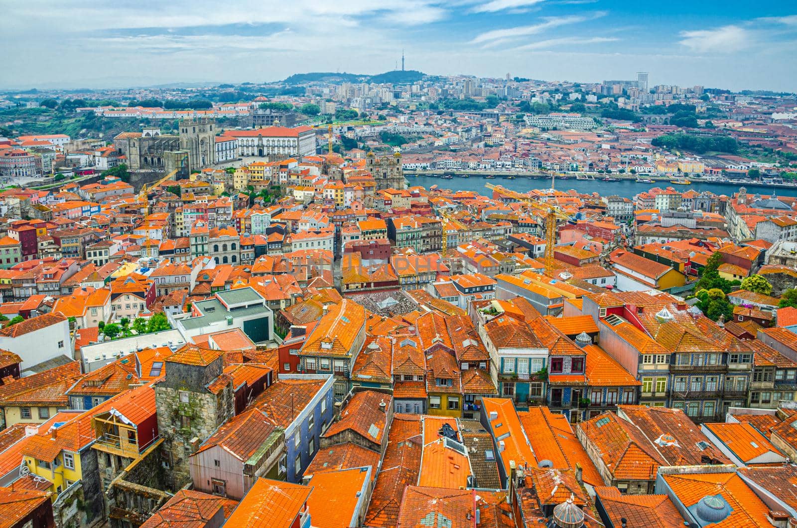 Aerial panoramic view of Porto Oporto city historical centre with red tiled roof typical buildings, Porto Cathedral, Douro River and Vila Nova de Gaia city background, Norte or Northern Portugal