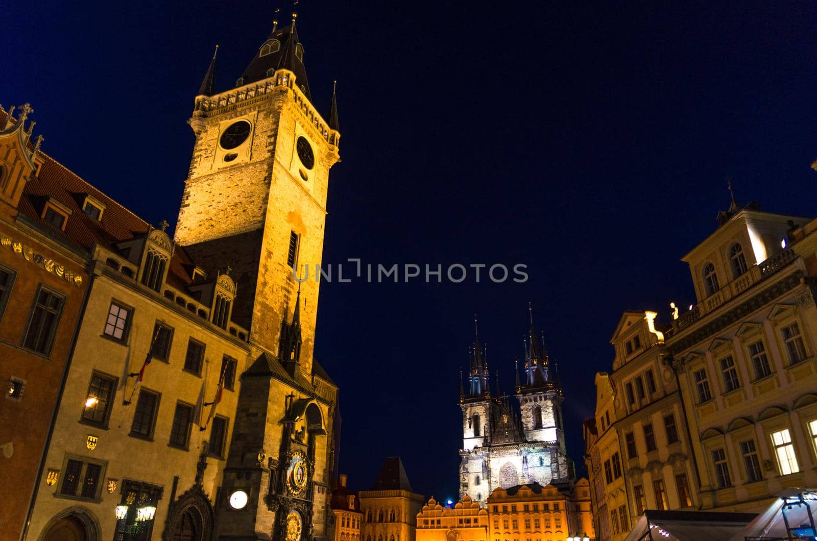 Prague Old Town Square Stare Mesto historical city centre. Astronomical Clock Orloj and Tower of City Hall building, Gothic Church of Our Lady before Tyn, night view, Bohemia, Czech Republic