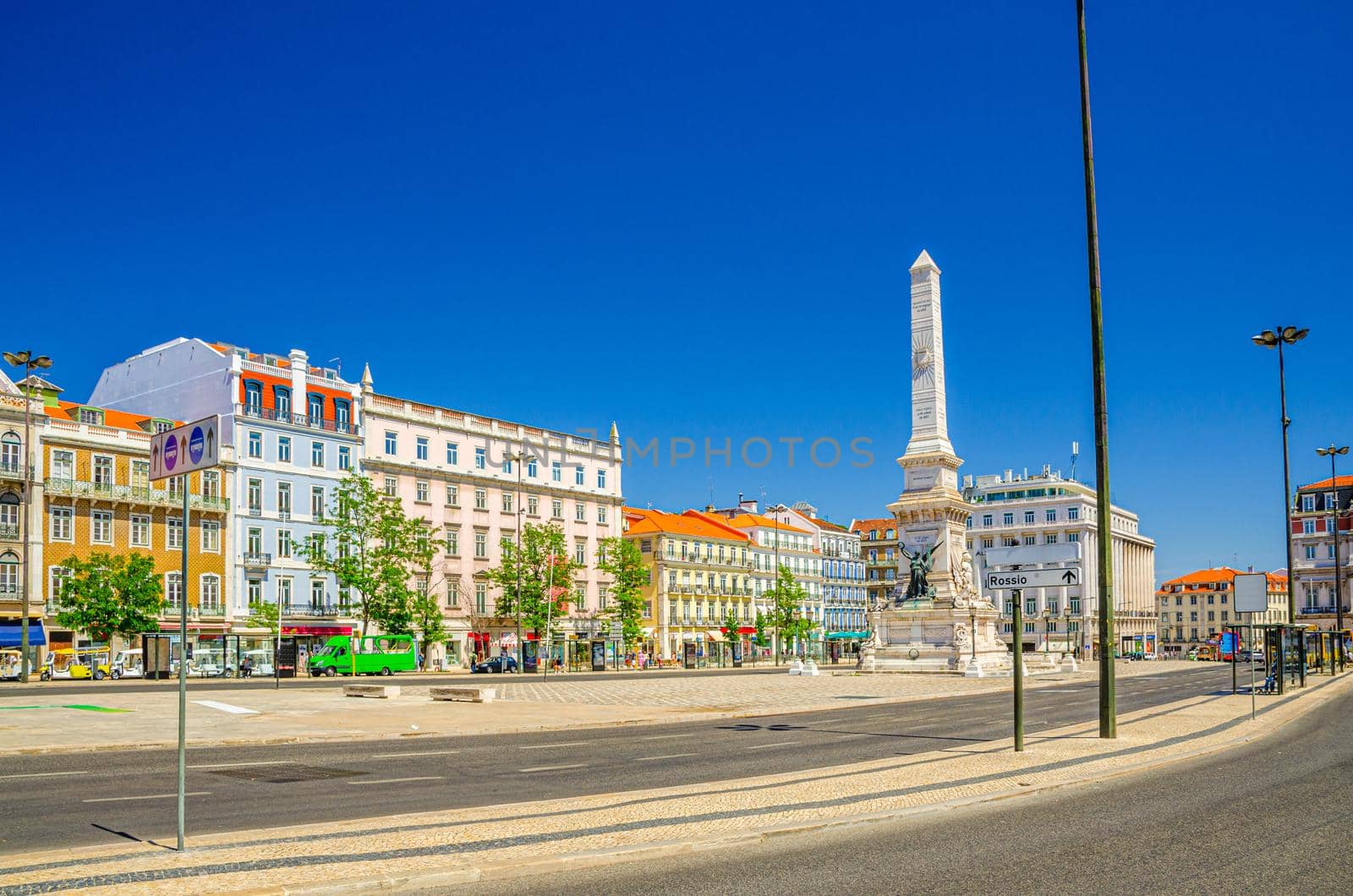 Restauradores Square with Monument to the Restorers or Monumento aos Restauradores and traditional colorful buildings in Lisbon Lisboa historical city centre, blue sky in sunny summer day, Portugal