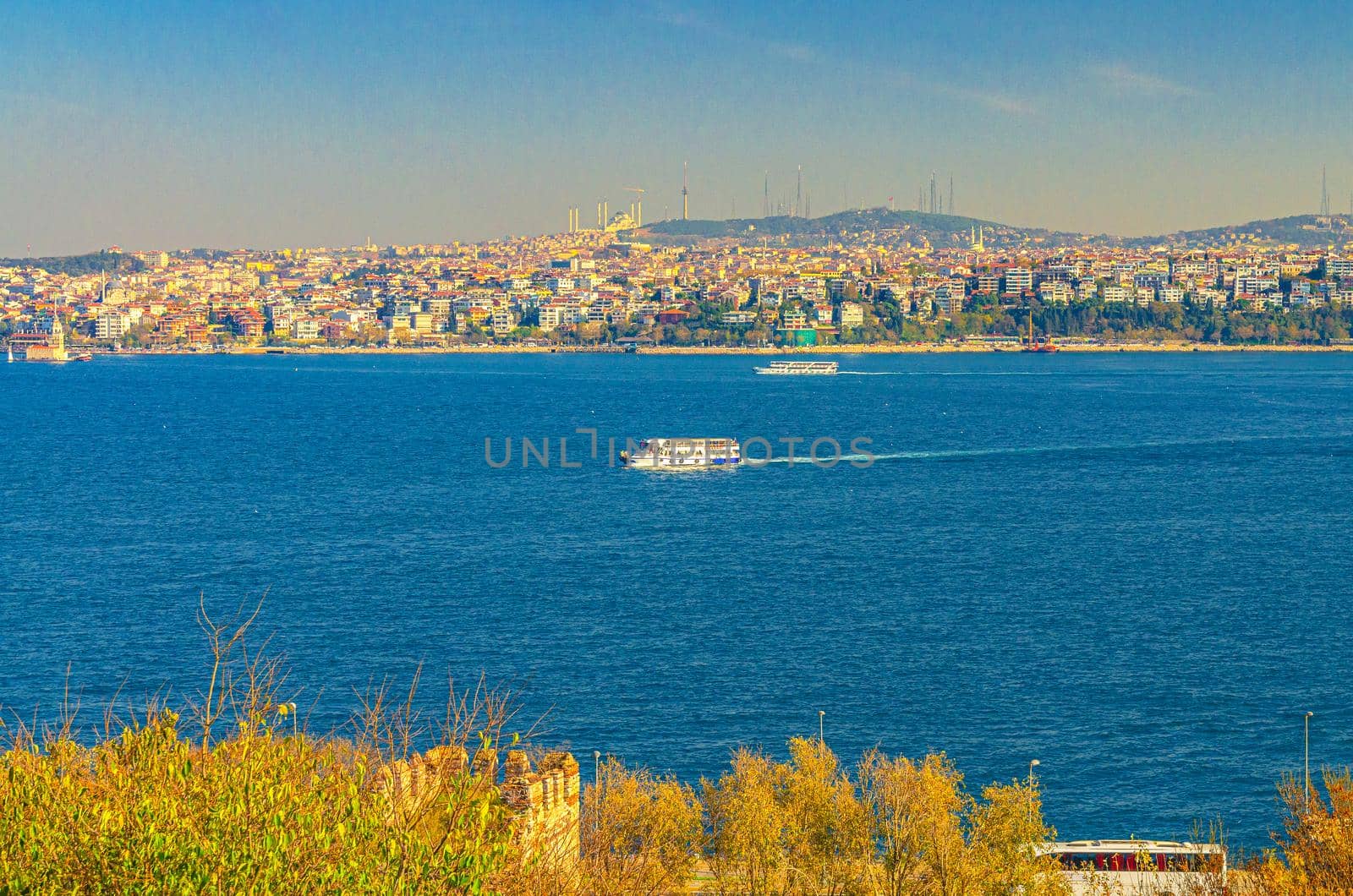 Cityscape of Istanbul city historical centre with ship boat sailing water of Bosporus Bosphorus Strait of Istanbul and Doganc lar district background, Turkey