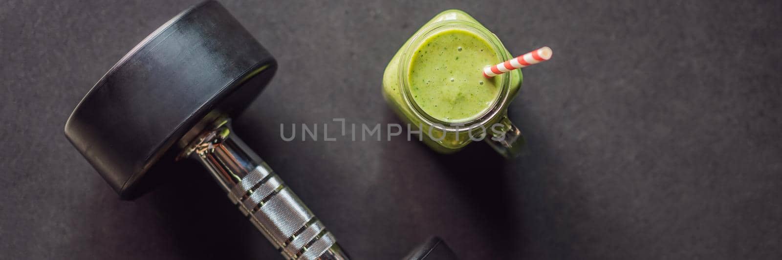 Green smoothies and dumbbells in the gym. BANNER, LONG FORMAT