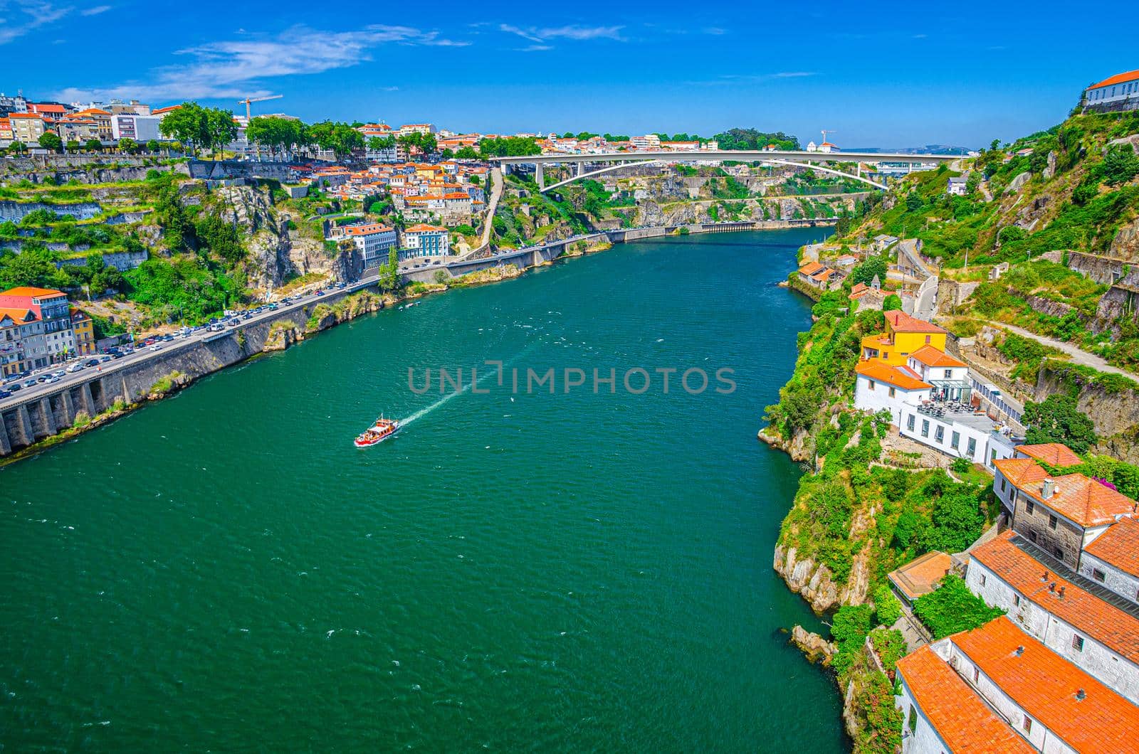 Aerial panoramic view of Porto Oporto city with Infante Dom Henrique Bridge ponte across Douro River with steep slopes between Ribeira district and Vila Nova de Gaia city, Norte or Northern Portugal