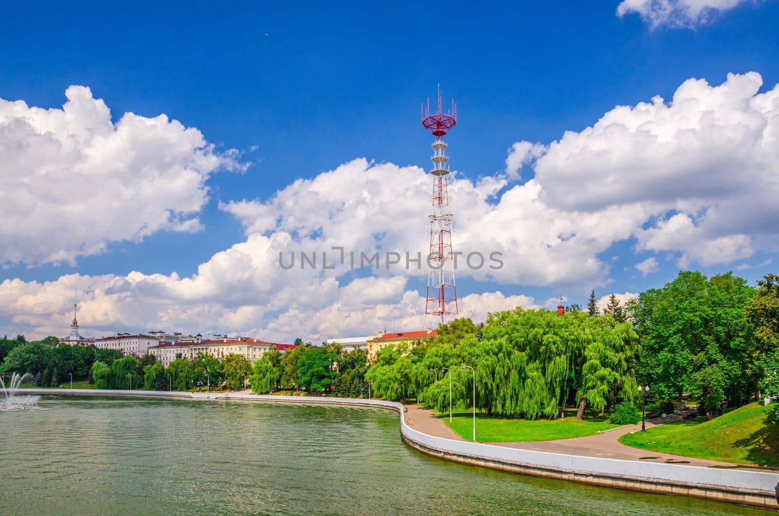 Minsk cityscape with Svislach or Svislac river embankment and television tower in historical centre, blue sky white clouds in sunny summer day, Republic of Belarus