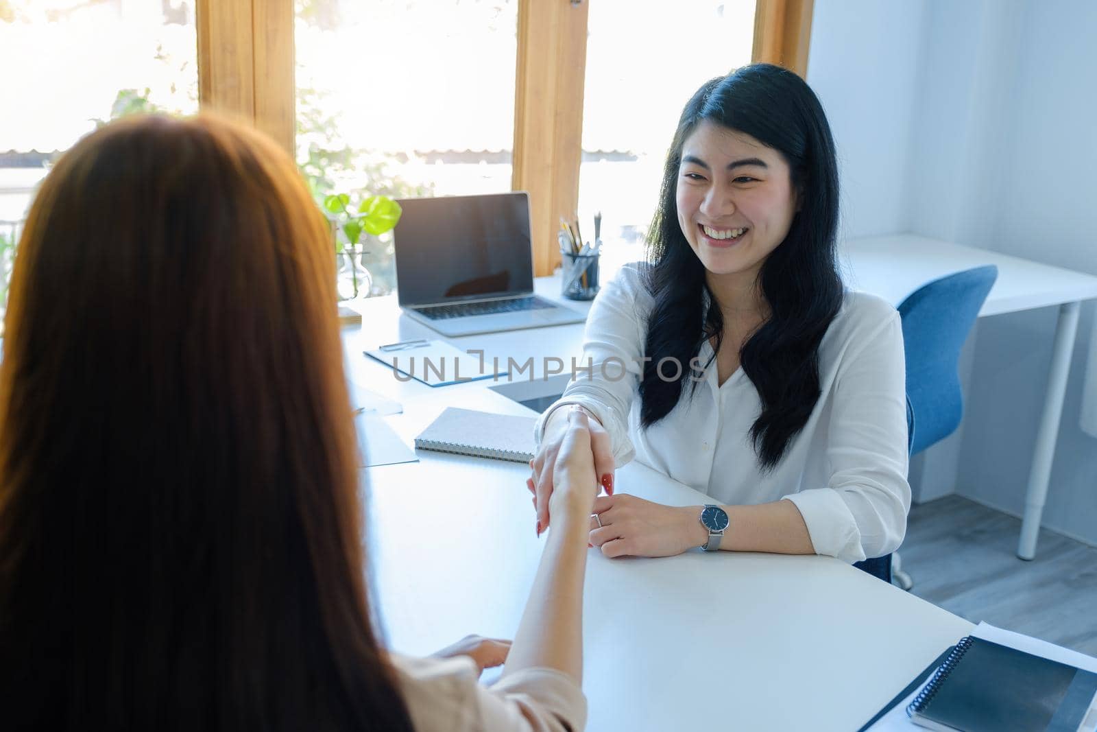 Young businesswoman collaborate with partners to increase their business investment network for Plans to improve quality next month in their office. agreement concept