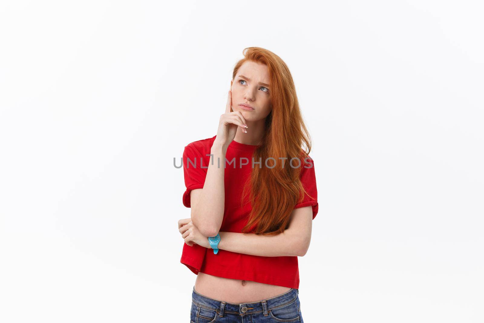 portrait of young happy woman looking and thinking over grey background