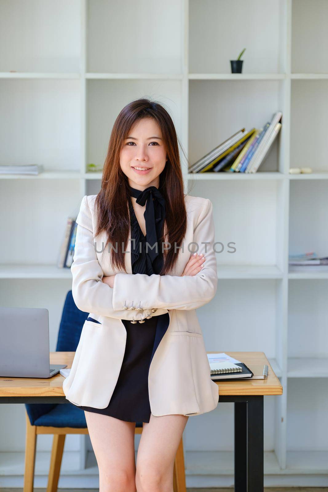 female entrepreneur showing a happy smiling face. by Manastrong