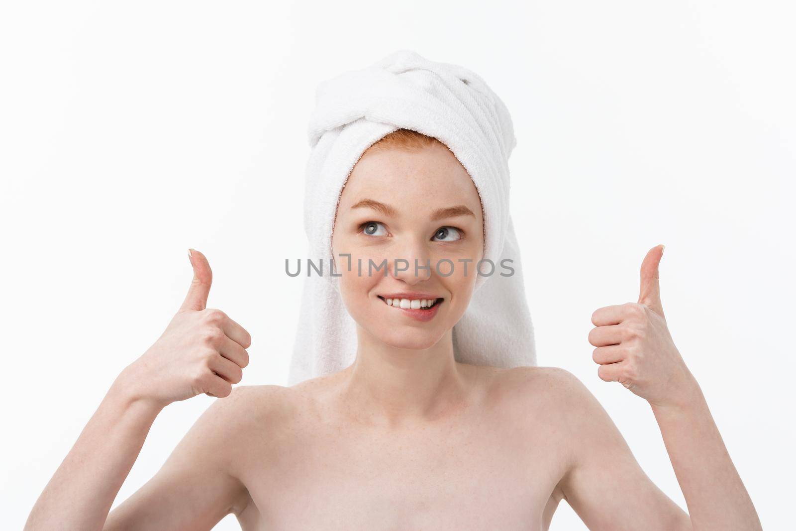 Portrait of young beautiful woman on white backgeound showing thumbs up