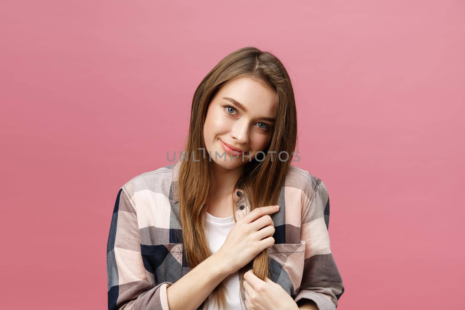 Portrait of beautiful brunette caucasian woman in pink studio.