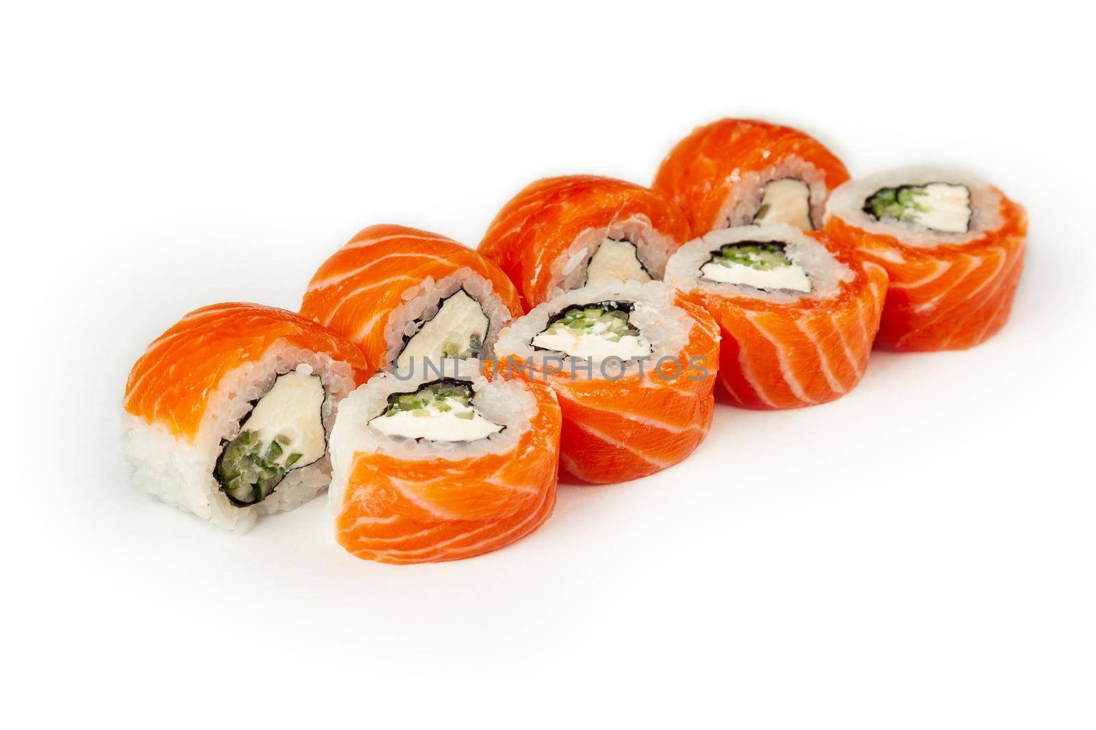 Sushi roll Philadelphia with cucumber on a white plate, classic Japanese sushi. Traditional Japanese food with maki. Delicious pieces of sushi. For the restaurant menu. copyspace.