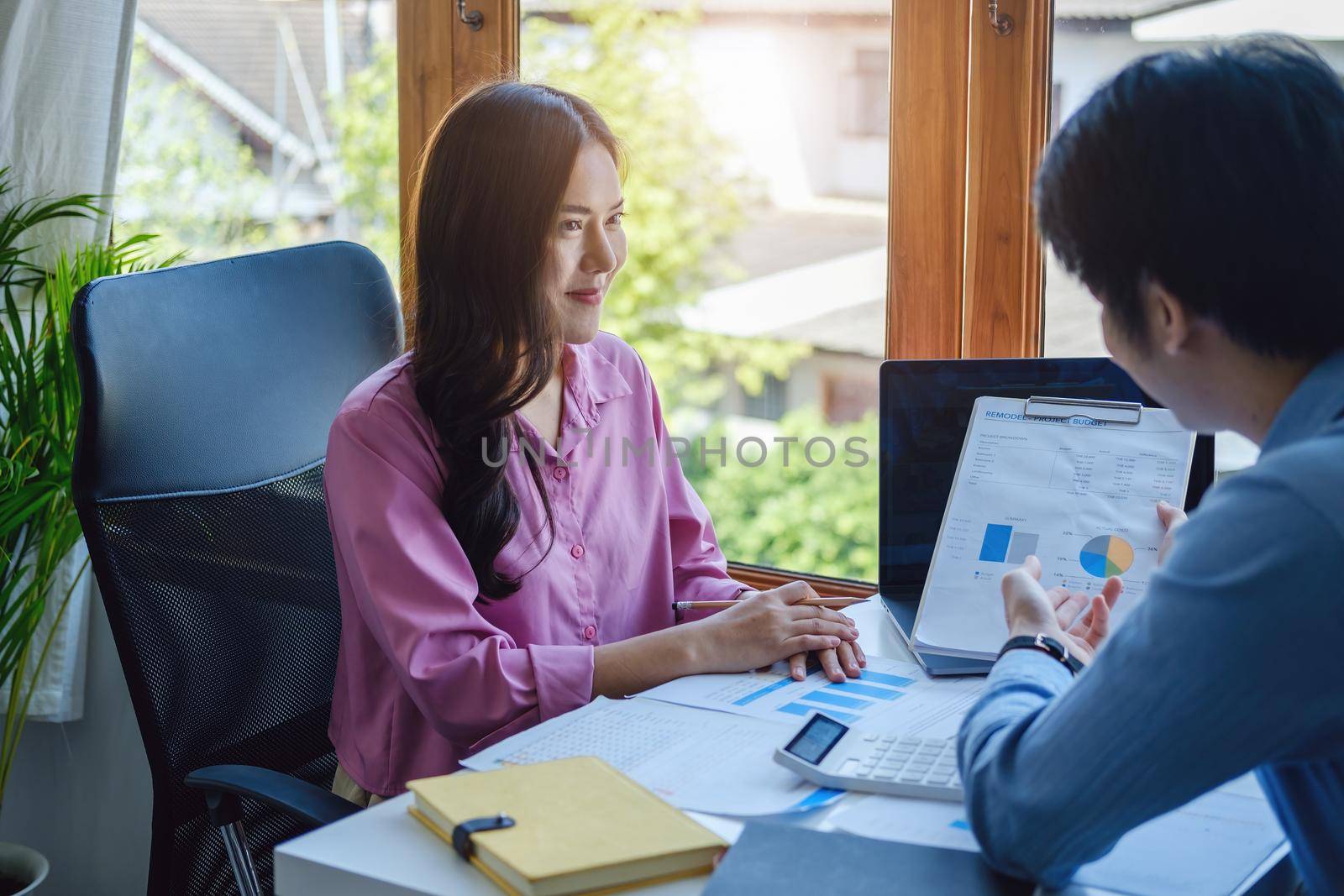 Teamwork concept, consultation, male economist pointing to budget, finance and investment documents, discussing and planning finances with female advisors in conference room by Manastrong