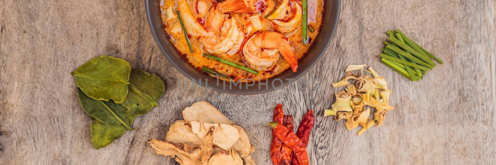 Prawn and lemon grass soup with mushrooms,Tom Yam Kung ,thai food in wooden background, top view. BANNER, LONG FORMAT