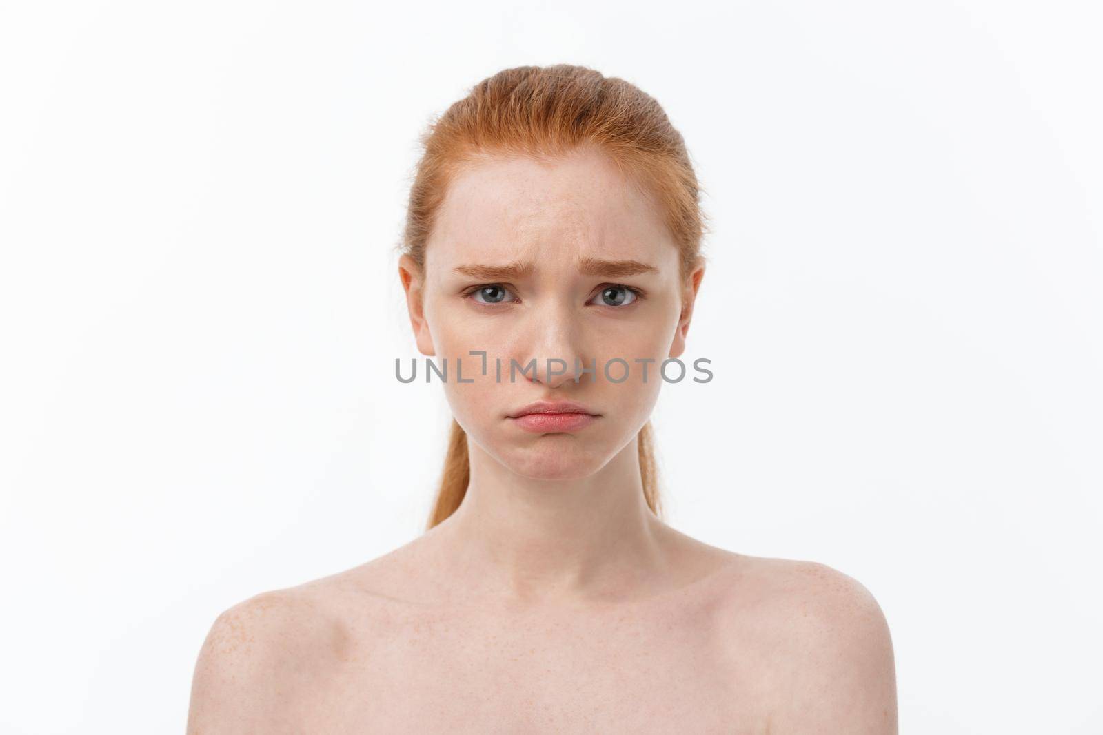 Portrait sad serious young woman with disappointed facial expression.. isolated on white background, looking at camera.