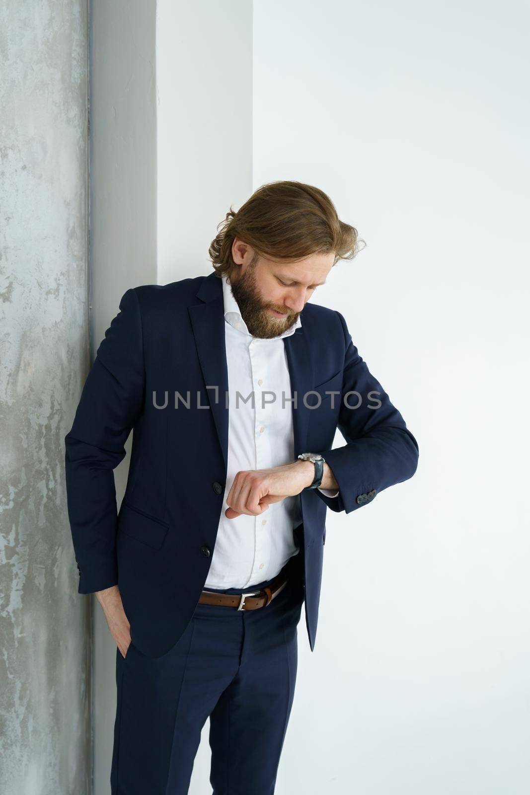 a handsome brutal bearded and long-haired man, a stylish businessman on a white background by vladimirdrozdin