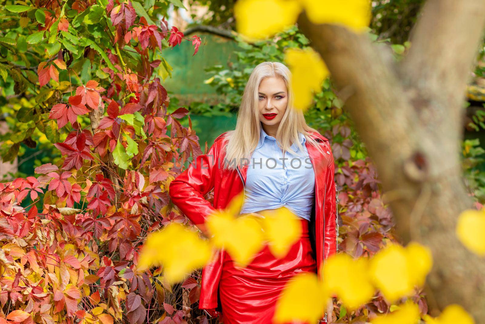 Stylish blonde woman on autumn street by Bonda