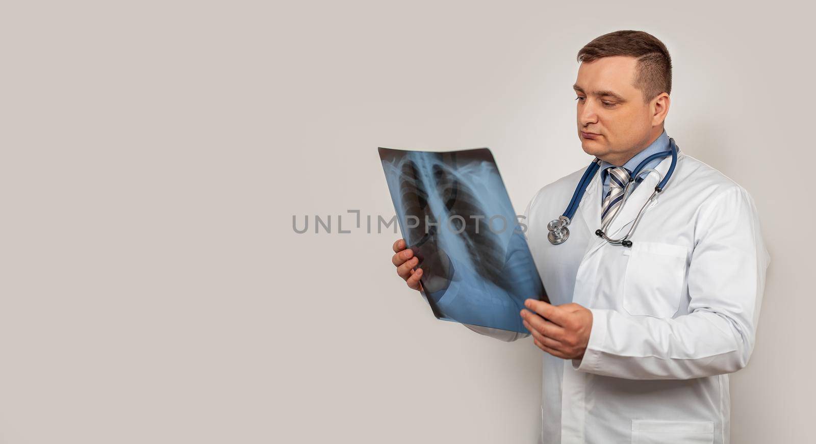 A male doctor looks and studies an x-ray of the chest. A snapshot of a person s lungs with signs of pneumonia. A genetic snapshot of small cell lung cancer