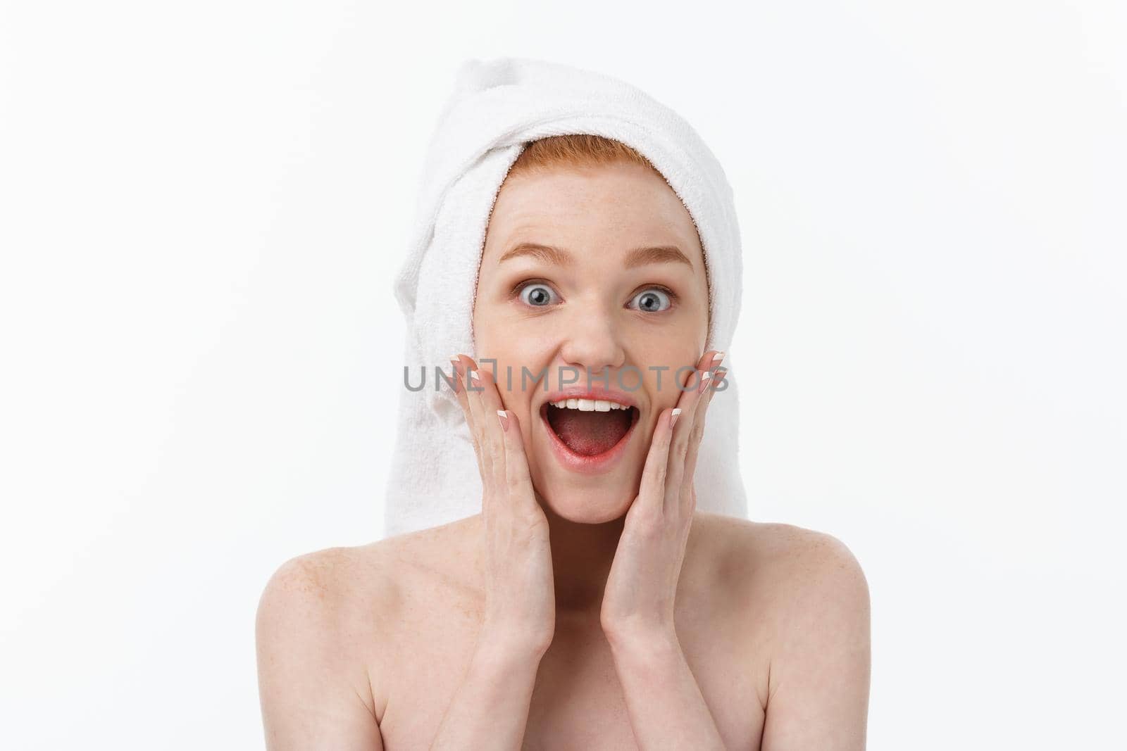 Surprised Beautiful Young Woman After Bath with A Towel On Her Head Isolated On white Background. Skin Care And Spa Theme