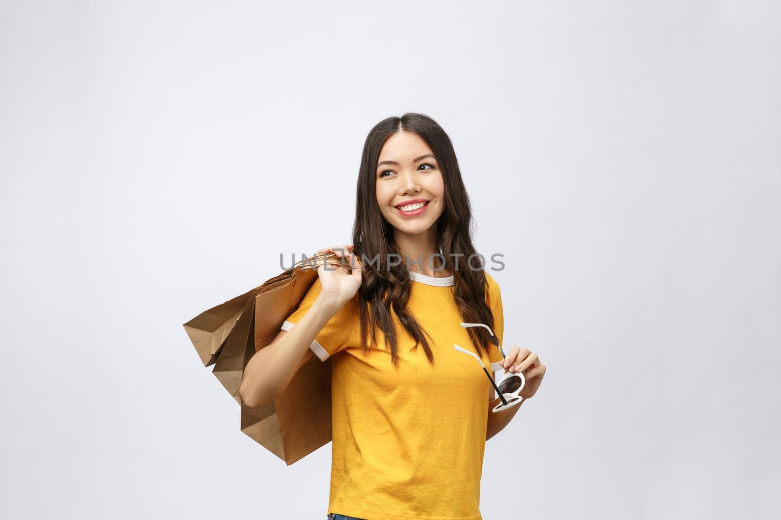 Beautiful Attractive Asian Woman smile and holding shopping bags feeling so happiness and enjoy with black Friday sale in Shopping mall,isolated on white background,Shopping Concept. by Benzoix